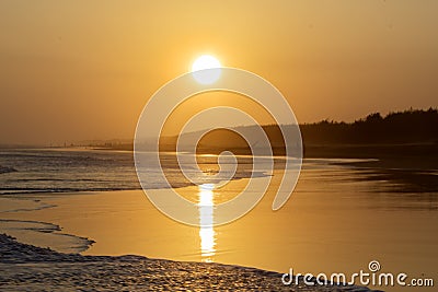 Tropical beach with warm sunset at dusk time Stock Photo