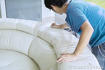 Unknown male worker wiping white leather couch Editorial Stock Photo