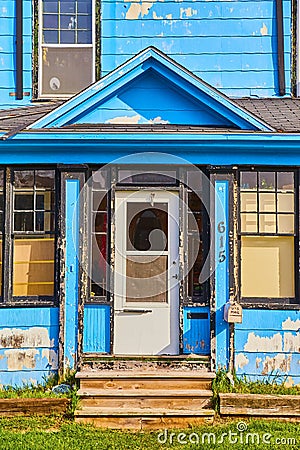 Urban building with chipped blue and white paint at 615 house and mailbox Editorial Stock Photo
