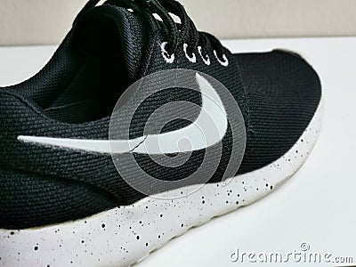 Image of used running shoe by Nike. Editorial Stock Photo