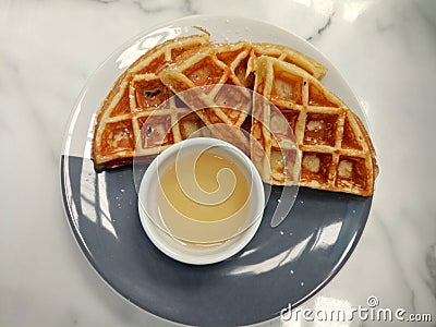 image of waffles with honey syrup for breakfast . Stock Photo