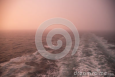 Sunset, wake and rainstorm Stock Photo