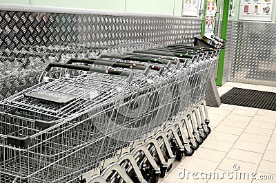 Wheeled grocery carts in a supermarket Stock Photo
