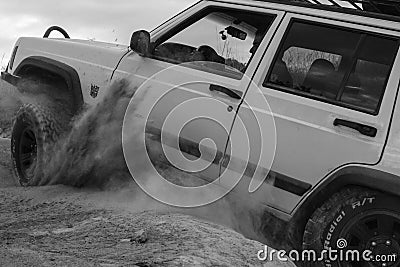 Image of a white jeep trying to move in the soil in black and white. Editorial Stock Photo