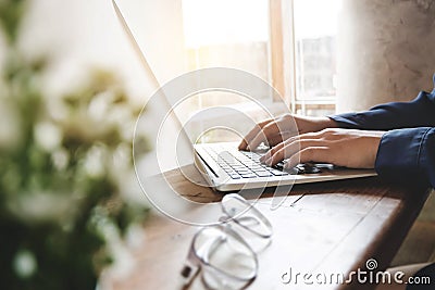 Image of woman hands using / typing on laptop computer selected focus on keyboard Stock Photo