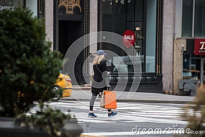 Female shopper walking in New York City Editorial Stock Photo