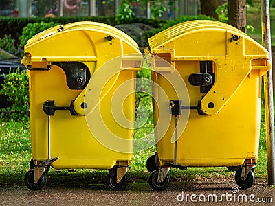 Image of Yellow waste Containers, Recycling bin for special Rubbish, during hail and rainy weather Stock Photo