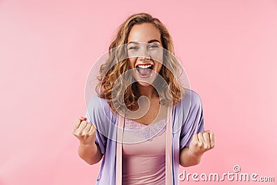 Image of young delighted woman screaming and making winner gesture Stock Photo