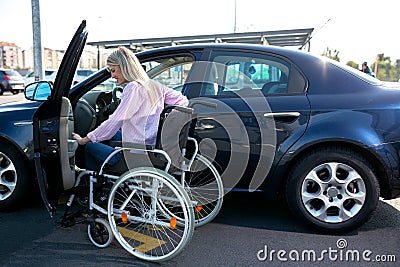 Image of young disabled woman trying to reach her car Stock Photo