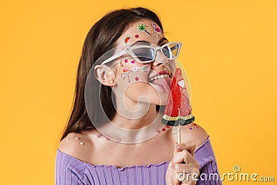 Image of young funny woman liking lollipop and smiling Stock Photo