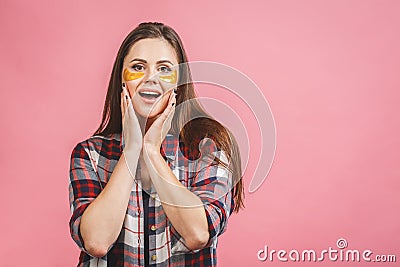 Image of young pure beautiful gentle woman isolated, take care of her skin with under eye golden patches Stock Photo