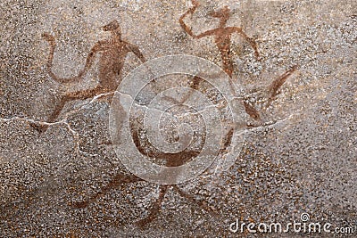 Images of ancient people from ocher on the wall of the cave. Stock Photo