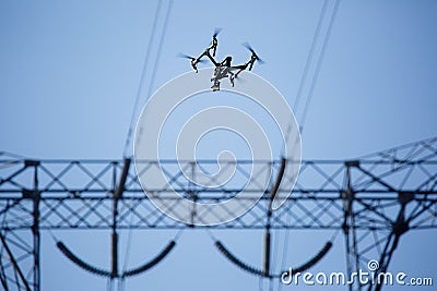 Images of power line tower. Drone making inspection around it. Stock Photo