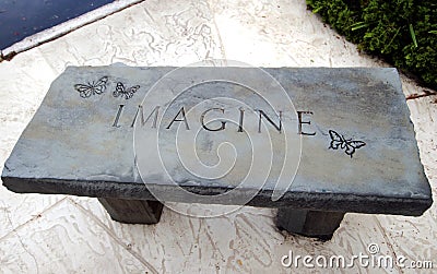 Imagine concrete bench engraving. Stock Photo