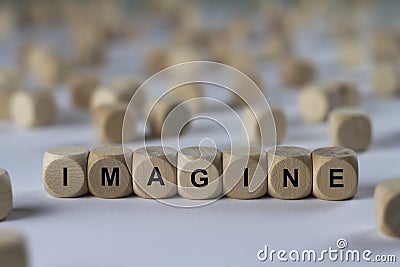 Imagine - cube with letters, sign with wooden cubes Stock Photo
