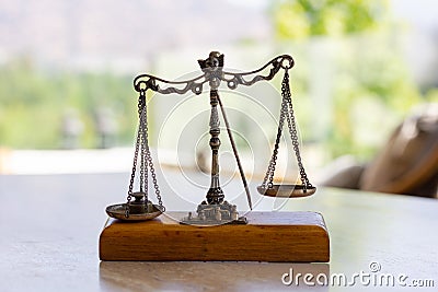 Imbalanced weighing scale miniature Stock Photo