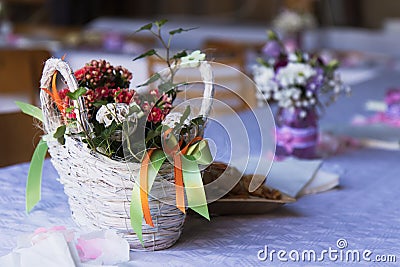 Beautiful floral decoration on the table in a wooden basket, wedding table ornament Stock Photo