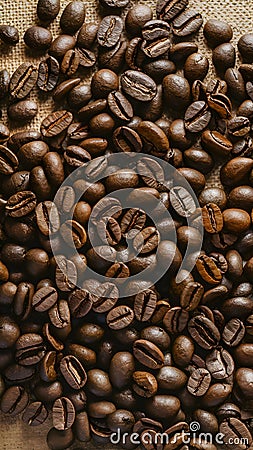 Img Close up photo of numerous coffee beans on textured beige surface Stock Photo