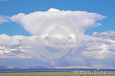 Immense Cumulonimbus cloud over red cliffs of northern Arizona Stock Photo