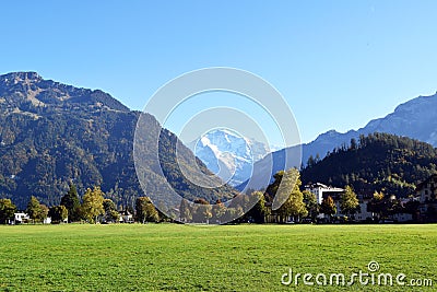 Interlaken, Switzerland, Immense lawn garden surrounded by giant mountains Stock Photo