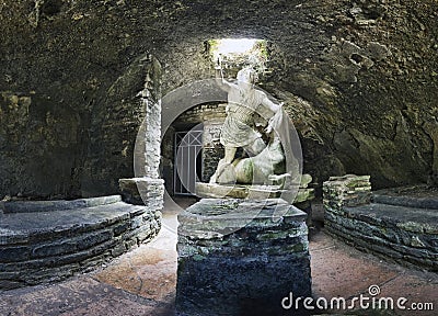 Immersive view of God Mithras statue in the act of killing bull to sacrifice it, the beautiful cave is located in the thermal s Stock Photo