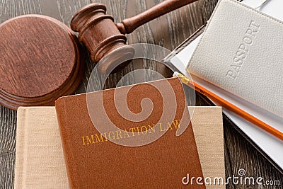 Immigration law, gavel and passport on wooden background Stock Photo