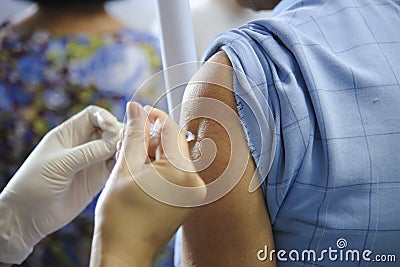 Immunization vaccine injection , doctor inject vaccine to patient arm Stock Photo