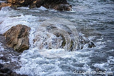 Impact of large waves against rocks Stock Photo
