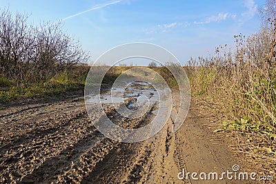 Impassable dirt road. Puddle and dirt on the road Stock Photo