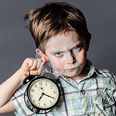 Impatient young boy with a dark look reproaching alarming deadlines Stock Photo