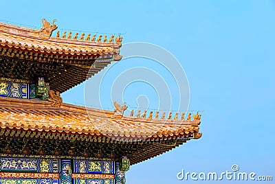 The Imperial Palace in Beijing Forbidden City. curved roofs in traditional Chinese style with figures on the blue sky background Stock Photo