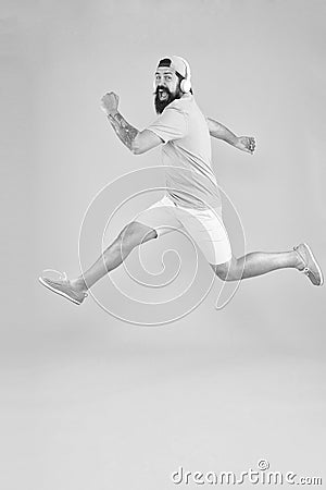 Impetuous movement. Hipster dancing jumping headphones gadget. Inspiring song. Music library. Energy of rhythm. Bearded Stock Photo