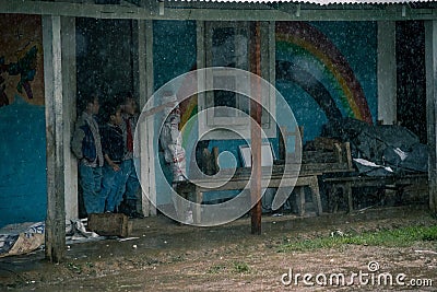 IMPHAL,MANIPUR, INDIA - Jul 19, 2019: Couple of School kids watching the rain Editorial Stock Photo