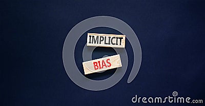 Implicit bias symbol. Concept words Implicit bias on wooden block. Beautiful black table black background. Business psychology Stock Photo