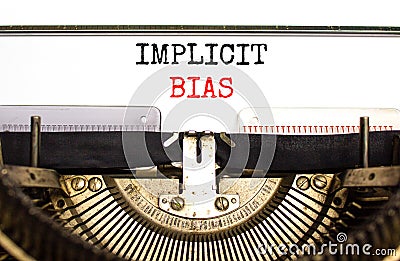 Implicit bias symbol. Concept words Implicit bias typed on white paper on old retro typewriter. Beautiful white background. Stock Photo