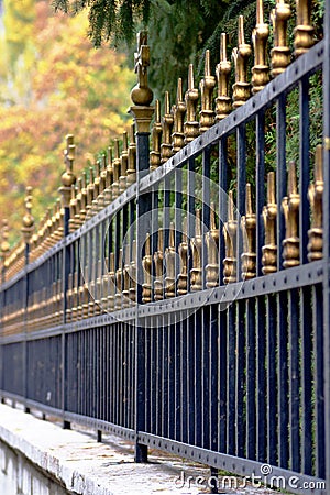 Close up detail image of tall iron crafted fence on stone wall Stock Photo