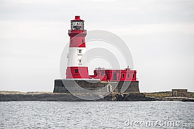 a large white and red lighthouse with a tower on top of it Stock Photo