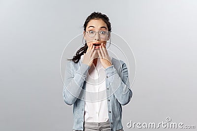 Impressed, excited attractive asian woman react to wonderful amazing news, hold hands near opened mouth, gossip with Stock Photo
