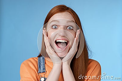 Impressed excited overwhelmed young redhead girlfriend fan screaming thrilled express afection adore awesome music band Stock Photo