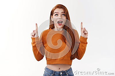 Impressed speechless attractive stylish redhead urban girl redhead ginger haircut show belly cropped top drop jaw Stock Photo