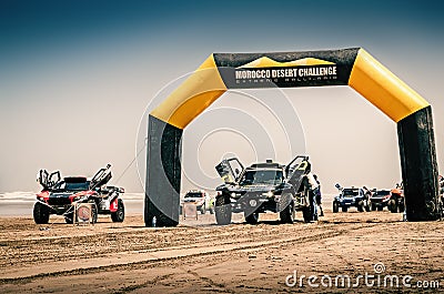 Impressive rally raid buggies on the beach of Plage Blanche on the start line of the Morocco Desert Challenge 2023. Editorial Stock Photo