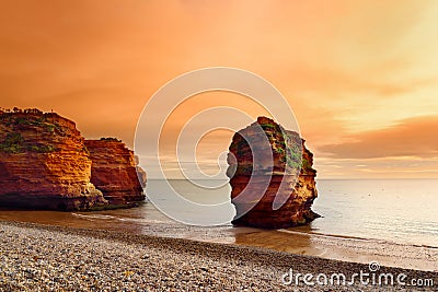 Impressive red sandstones of the Ladram bay on the Jurassic coast, a World Heritage Site on the English Channel coast of southern Stock Photo