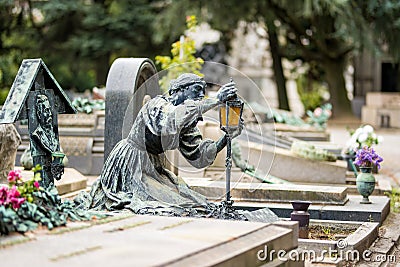 Impressive sculptures on the tombs and monuments of Cimitero Monumentale di Milano or Monumental Cemetery of Milan. Milan, Italy Editorial Stock Photo