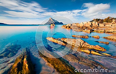 Impressive summer view of Sardinia island, Italy, Europe. Sunny morning scene of Porto Taverna beach with Tavolara mountain on bac Stock Photo