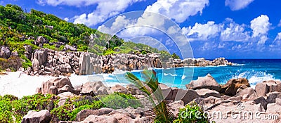 Impressive wild rocky beach Anse Marron in Seychelles. La Digue Stock Photo