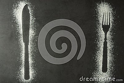 Imprint fork and knife silhouette made of flour on a black backgraund. Gluten free concept. Lose weight, dieting, healthy food Stock Photo