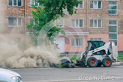 Improper cleaning of the road with a special machine. Very dusty and dirty Stock Photo