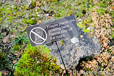 Improvised sign warning visitors to the gardens to stay off the rocks. Editorial Stock Photo