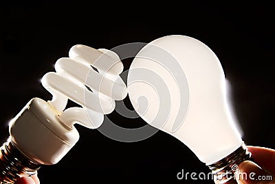 Incandescent and cfl lightbulb on black Stock Photo