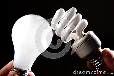 Incandescent and cfl lightbulb on black Stock Photo